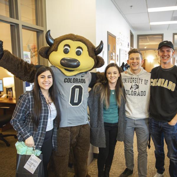 Chip visits New Student and Family Programs staff to hand out gift bags and pose for pictures during Random Acts of Kindness Week