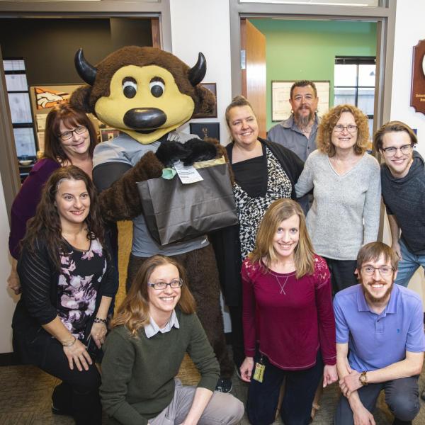 Chip visits Dining Services staff to hand out gift bags and pose for pictures during Random Acts of Kindness Week
