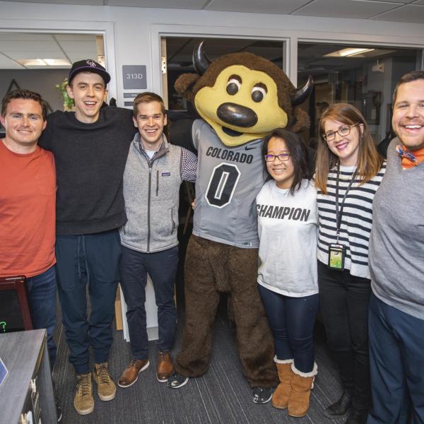 Chip visits Off-Campus Housing and Neighborhood Relations staff to hand out gift bags and pose for pictures during Random Acts of Kindness Week
