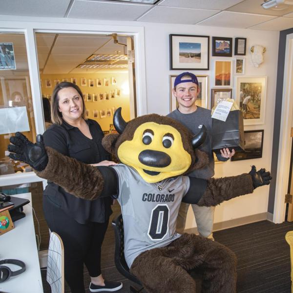Chip visits Volunteer Resource Center staff to hand out gift bags and pose for pictures during Random Acts of Kindness Week