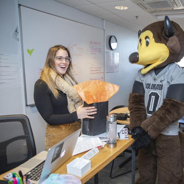 Chip visits Collegiate Recovery Center staff to hand out gift bags and pose for pictures during Random Acts of Kindness Week