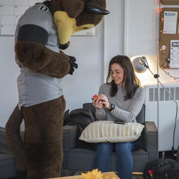 Chip visits Collegiate Recovery Center staff to hand out gift bags and pose for pictures during Random Acts of Kindness Week