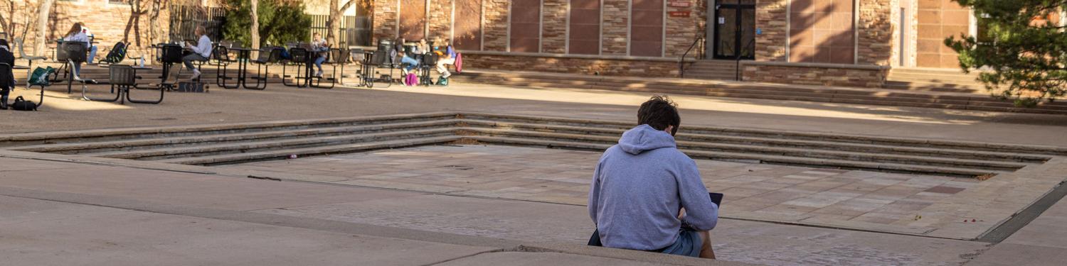 A student sitting outside the UMC