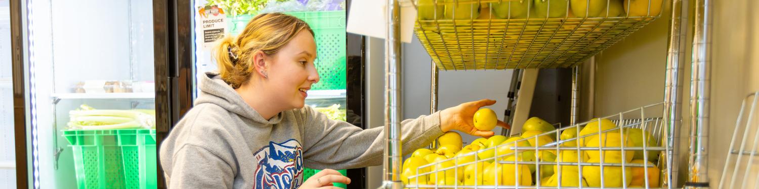 A student employee working at the Buff Pantry