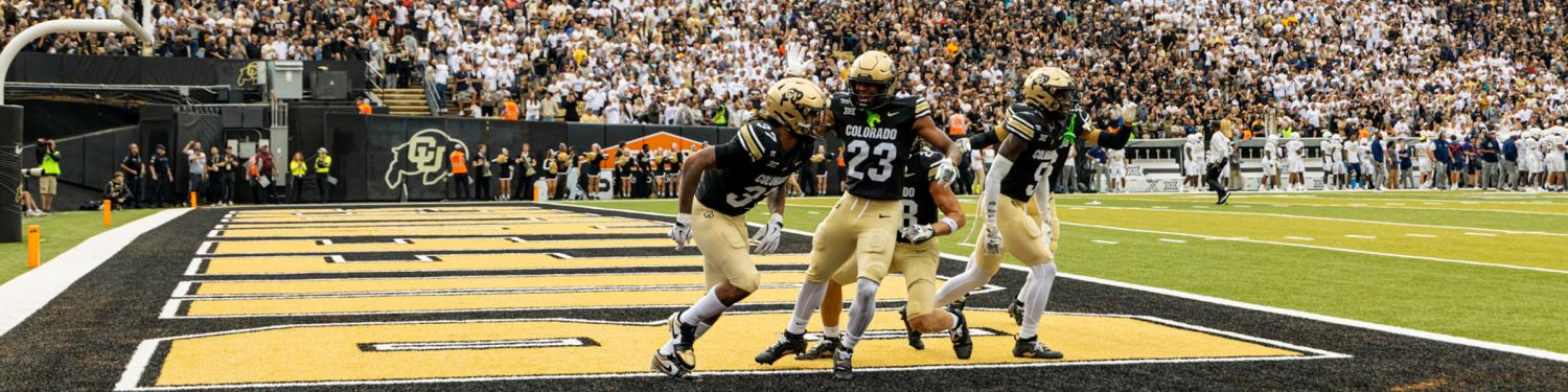 CU Buffs football players in the end zone at Folsom Field