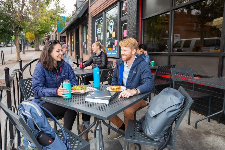 Students eat outside of the Sink restaurant