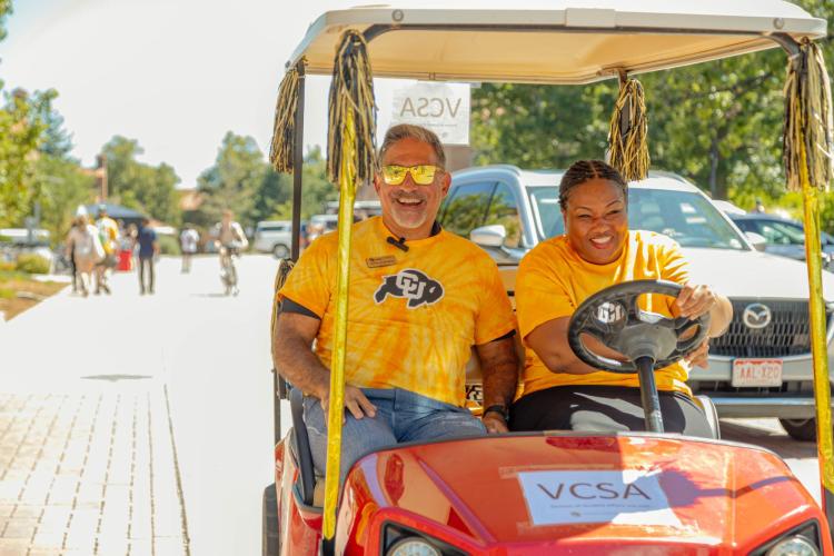 Dr. Mull and Chancellor Justin driving a golf cart