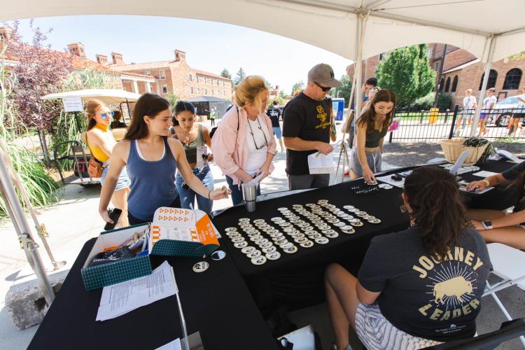 A student checks in at a move-in tent on campus during Fall Welcome