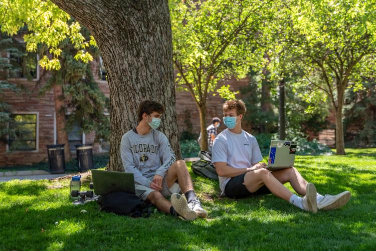 students sitting outsite