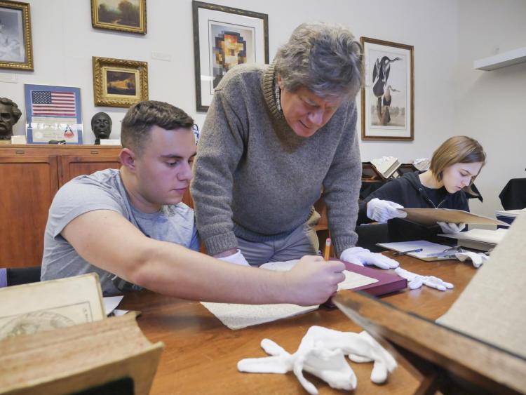 A faculty member works with a student