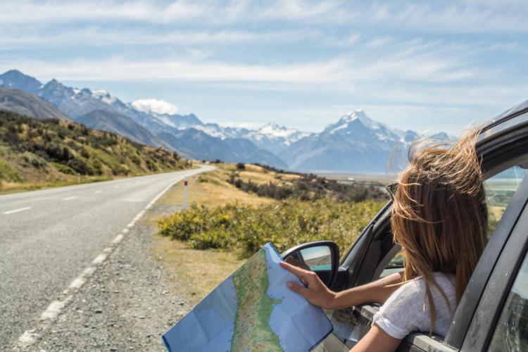 person looking at mountains from car window