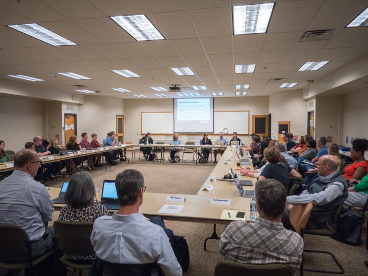 CU staff members sitting at tables during a meeting