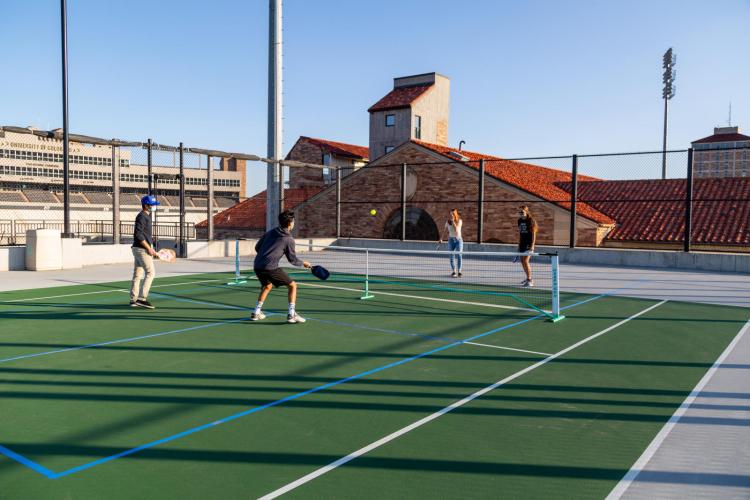 students playing tennis in masks