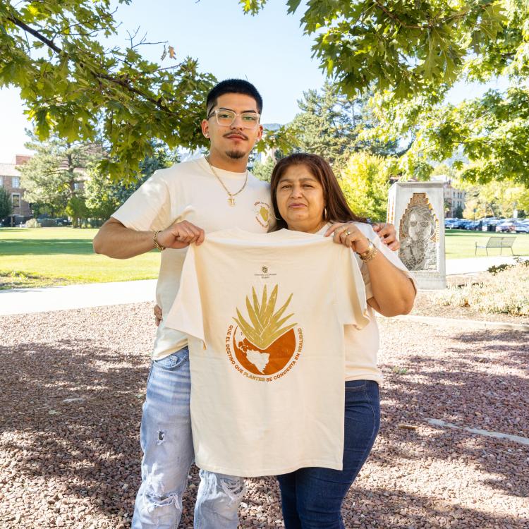 Yahir and his mother holding up the latin heritage month shirt