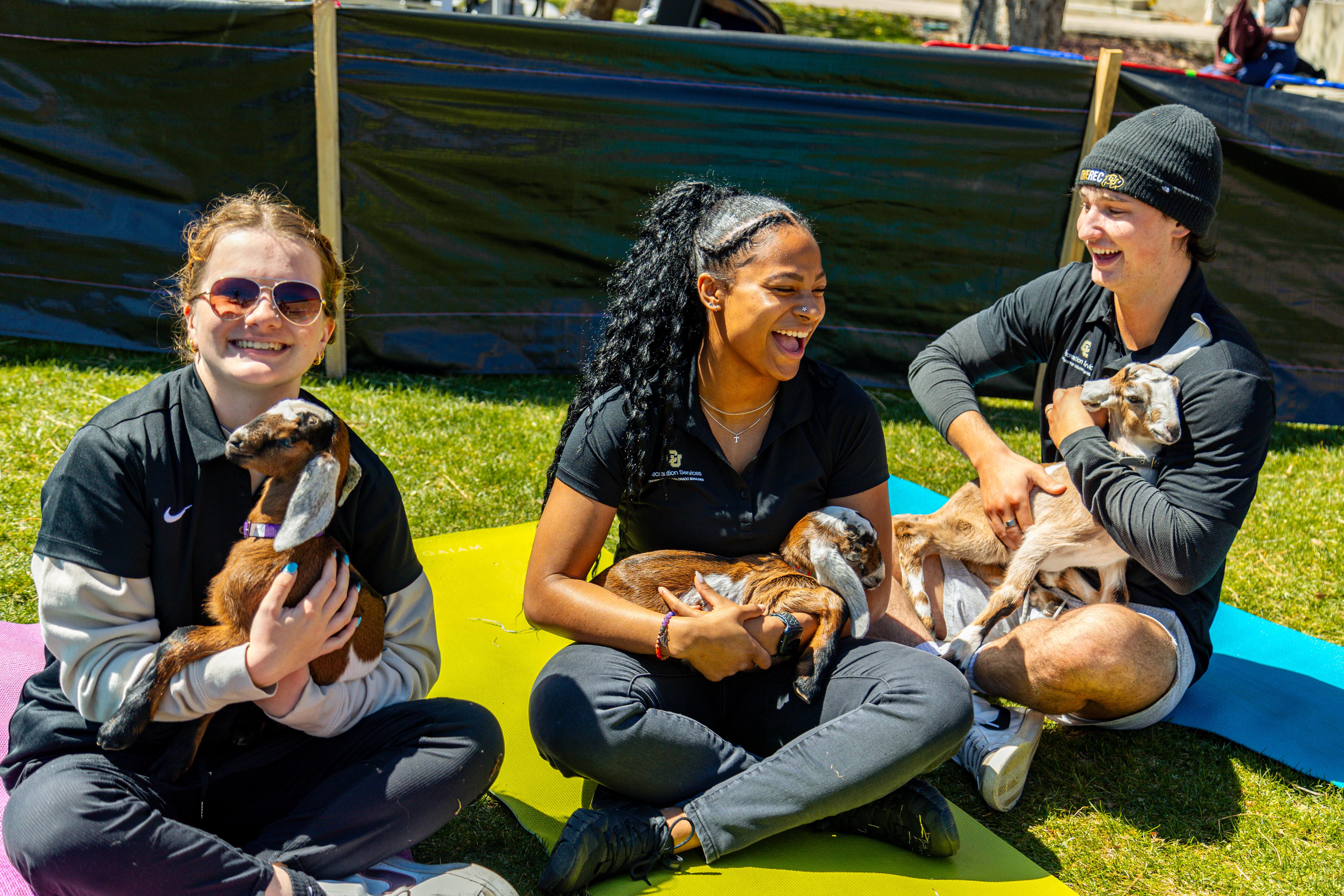 Student staff holding baby goats