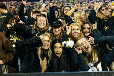 Students cheering at the Buffs football game