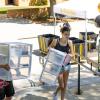 A student and family member carry belongings into a residence hall during move-in at CU Boulder