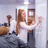 student writing on whiteboard