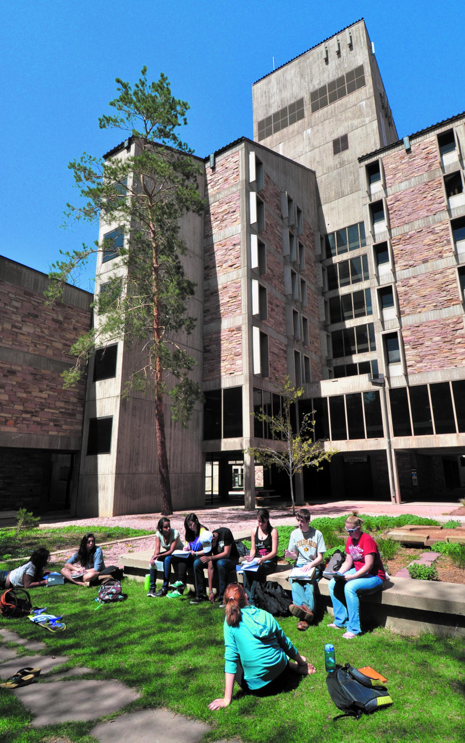 View of Engineering Building. Students are chatting outside.
