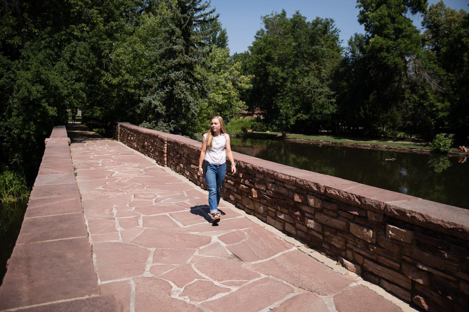 Summer Session Student walking near Varsity Lake.