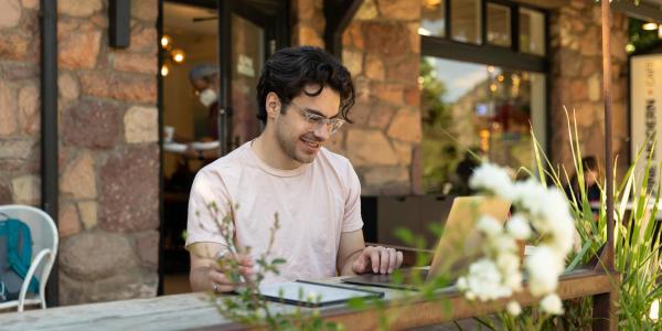 Photo of student looking at laptop