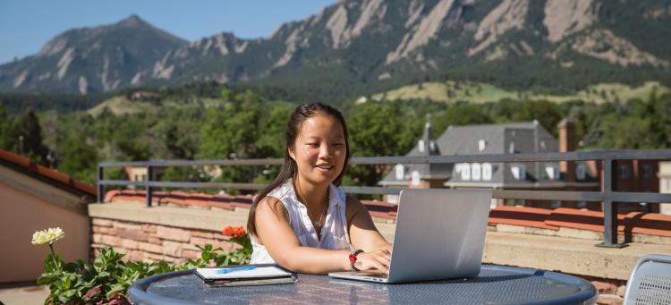 A female student studies on the roof of the UMC.