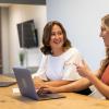 Photo of two students and a laptop
