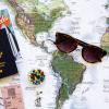 Image of map with sunglasses and a passport