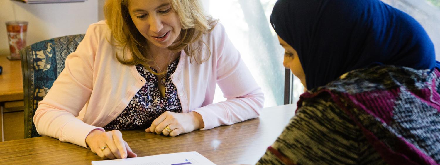 Advisor helping student in an office