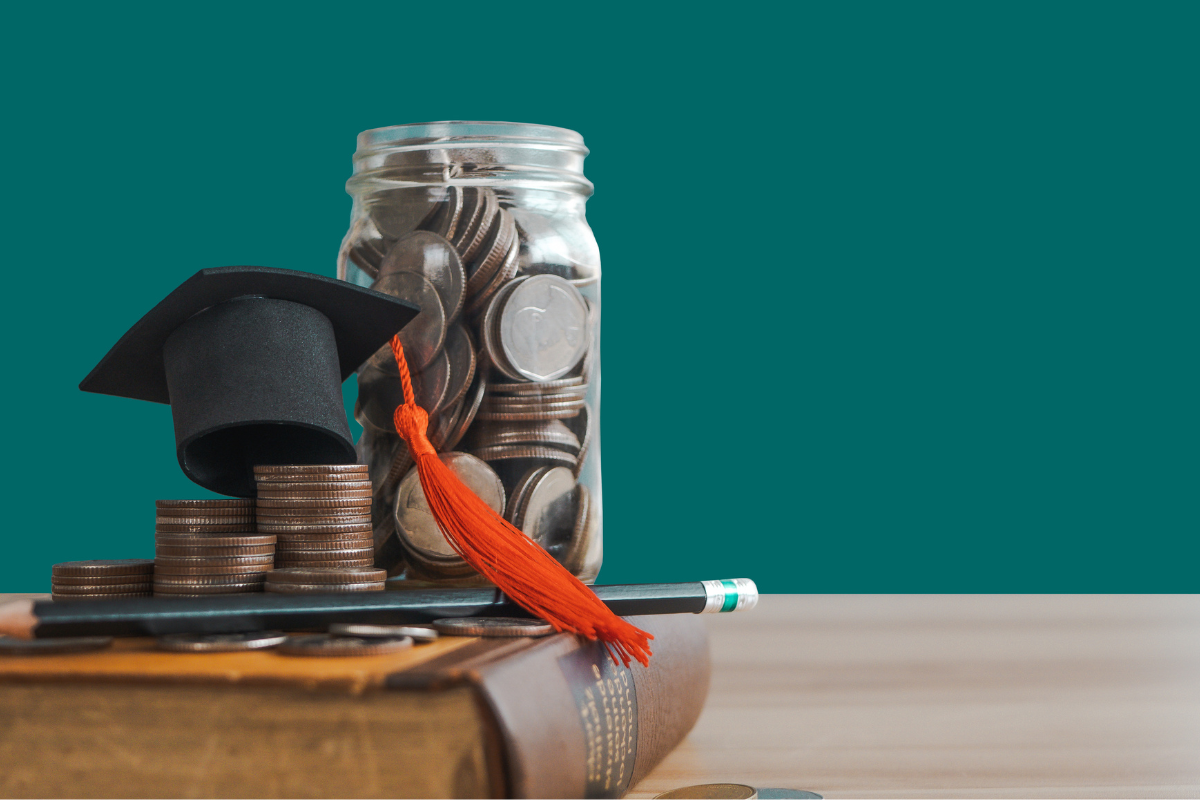 A jar of coins and a small grad cap