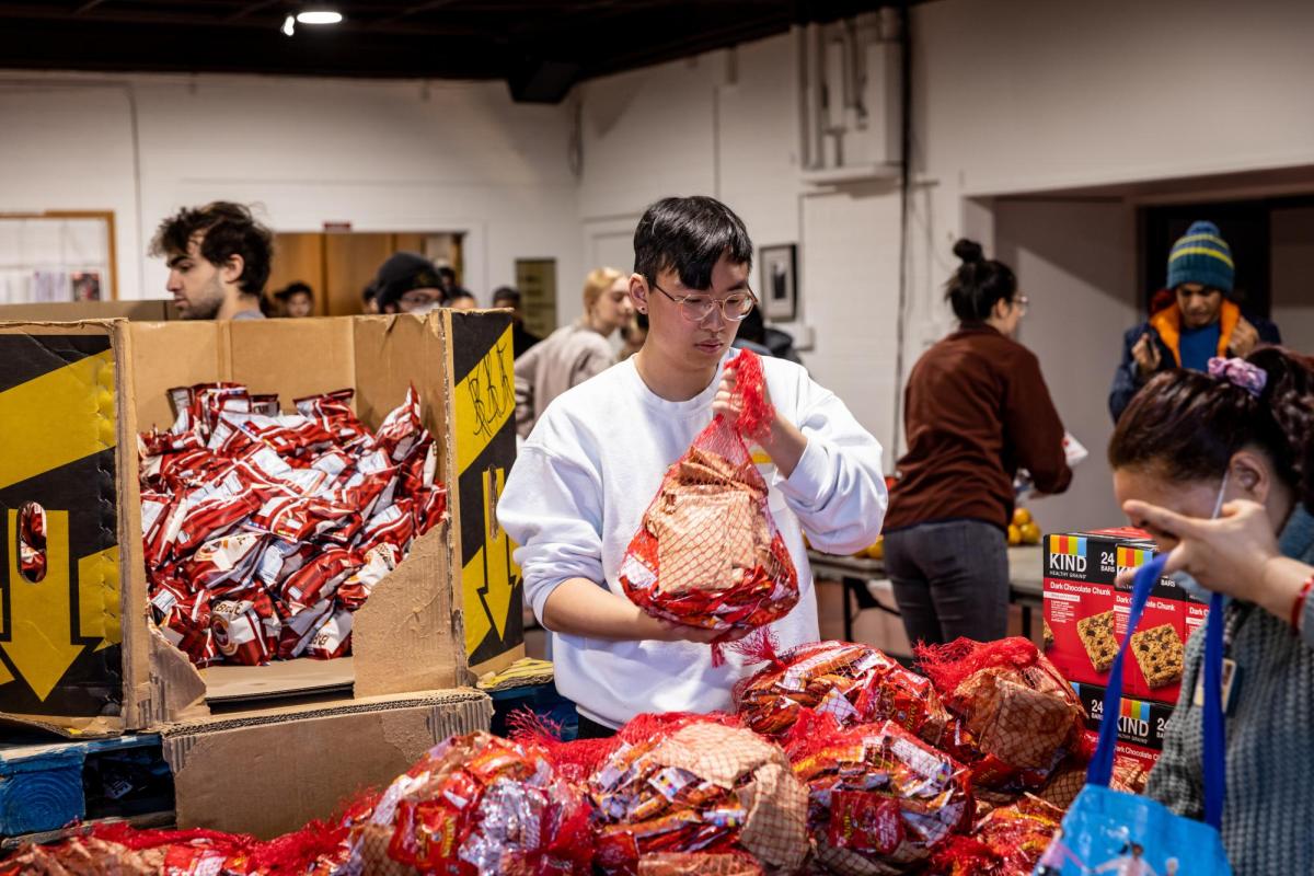 picture of Basic Needs Center volunteer distributing food