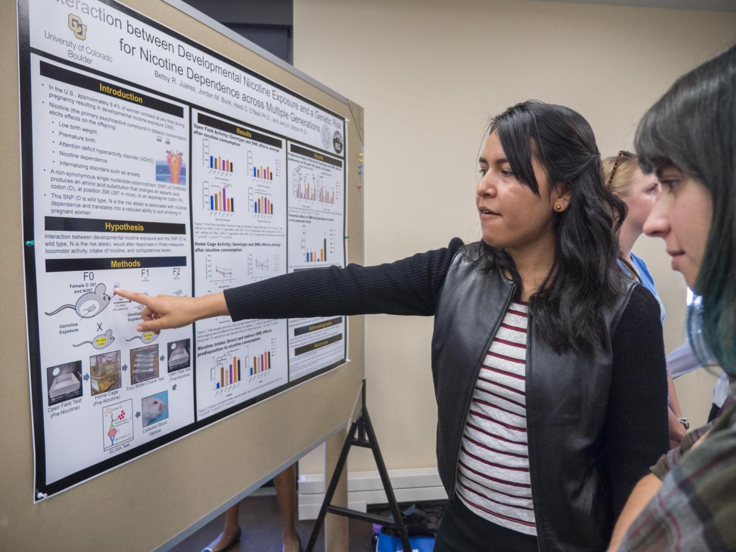 Students present their poster. Photo by Glenn Asakawa.