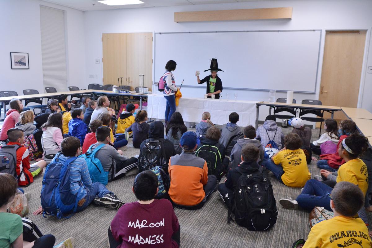 A CU Boulder Science Discovery instructor demonstrates Muggle Magic in front of visiting Angevine Middle School students.