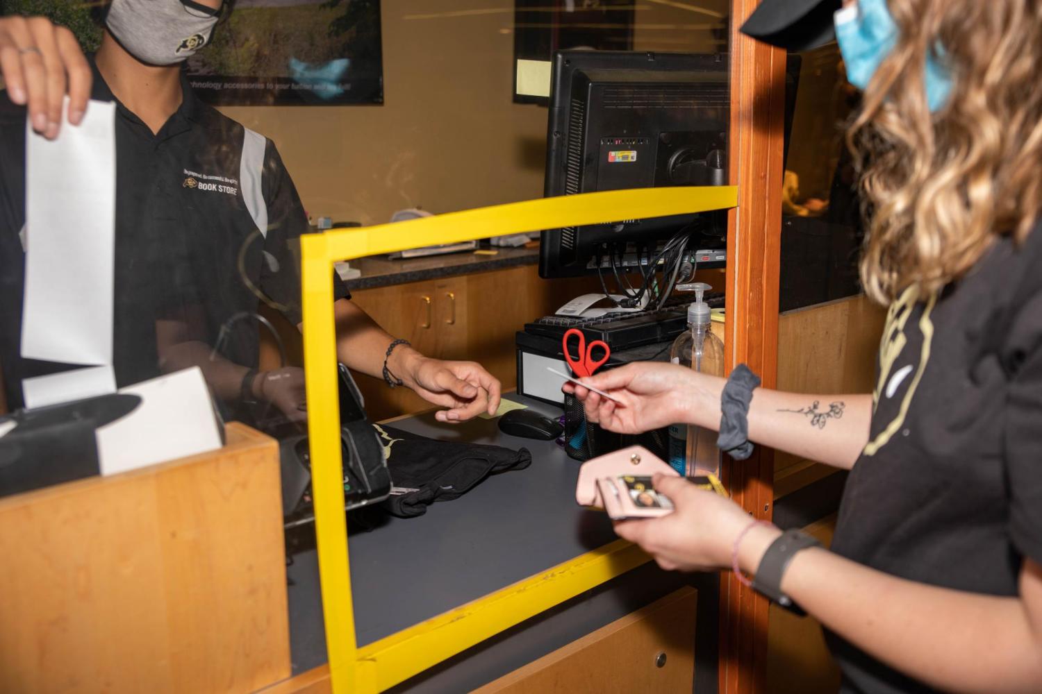 A student checks out at the CU Book Store register.