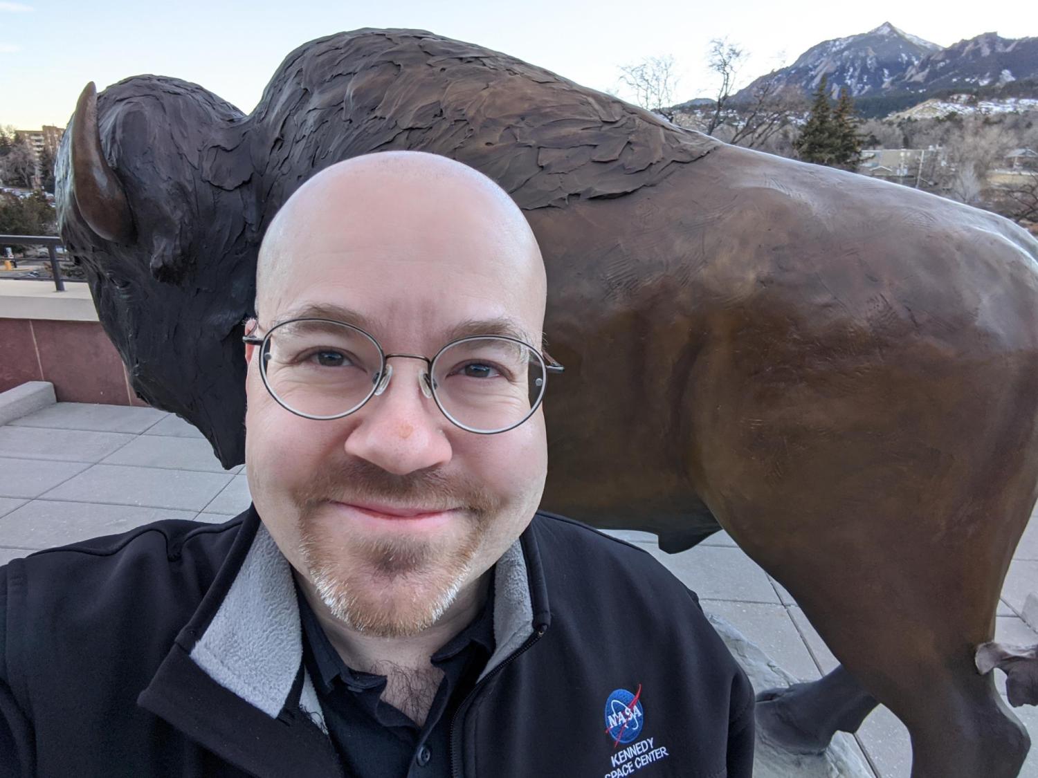 Dan Herrick poses in front of the Ralphie statue on the CU Boulder campus.