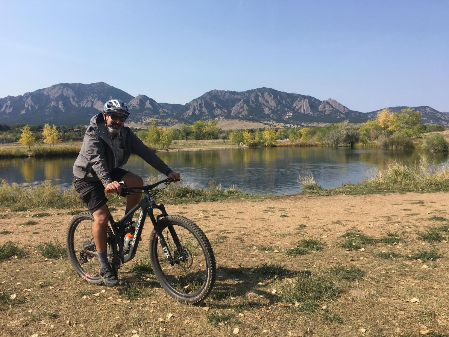 Derek Silva rides his bike at CU Boulder South.
