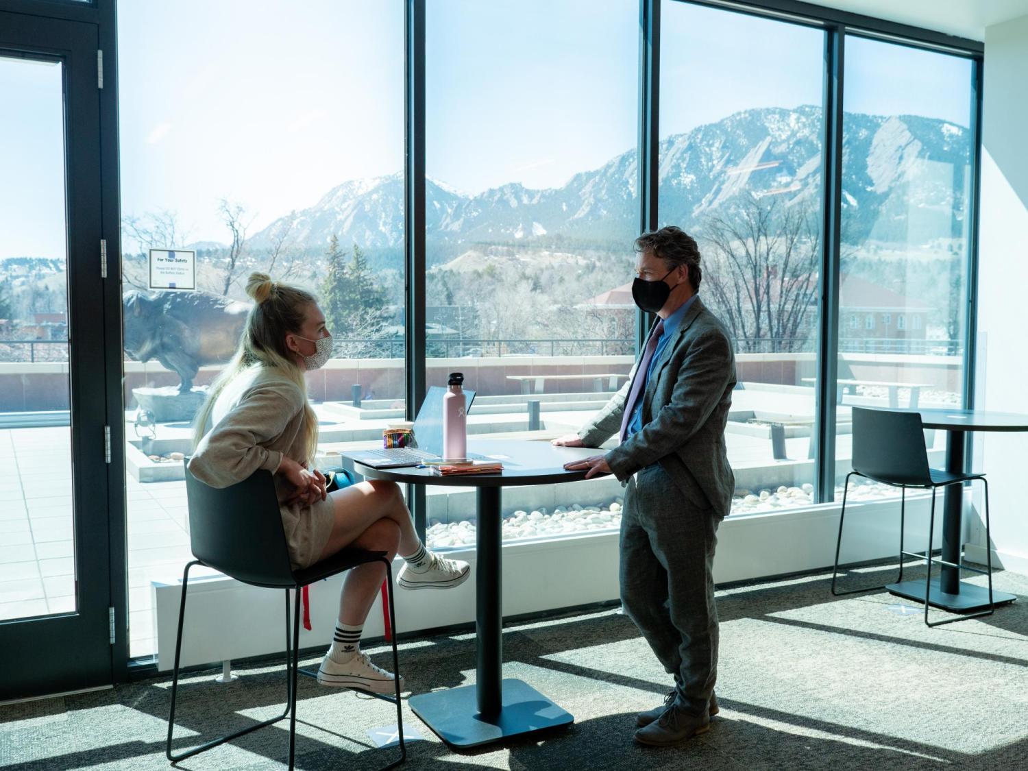 Patrick and student inside the CASE building, Flatirons in the background.