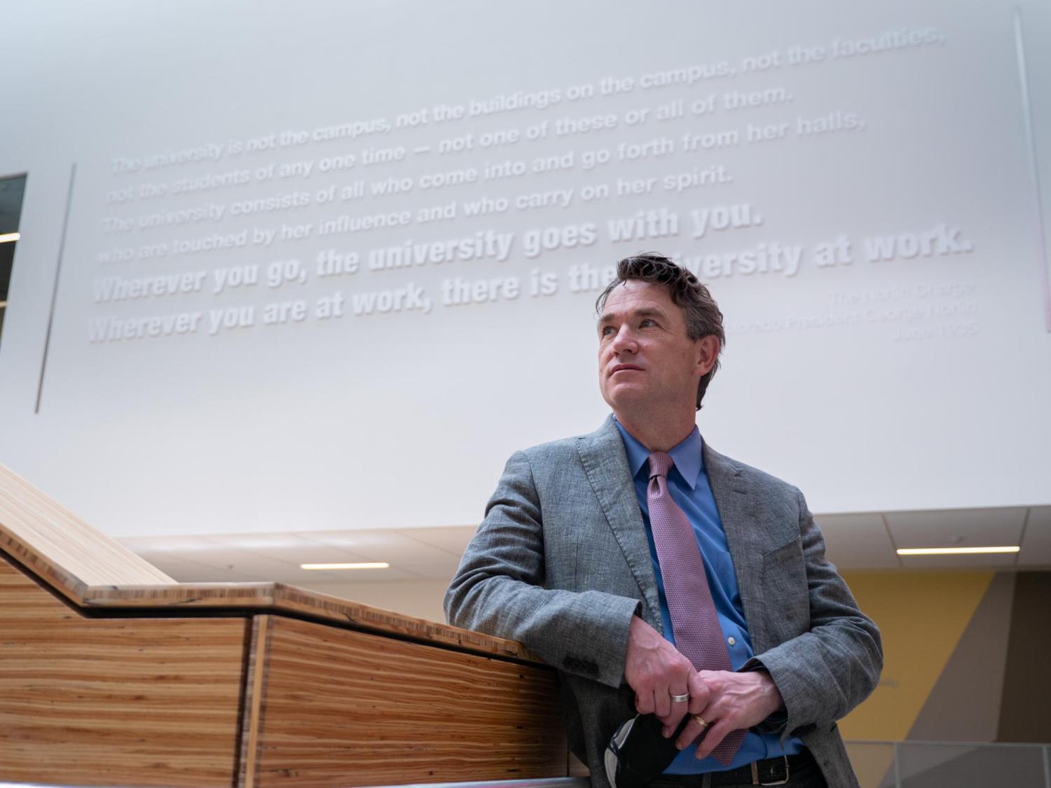 Pat standing beneath the Norlin Charge at the Center for Academic Success and Engagement (CASE). CU photo by Glenn Asakawa.