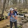 Abby Benson and her son hike through a forest in her home state of Rhode Island.