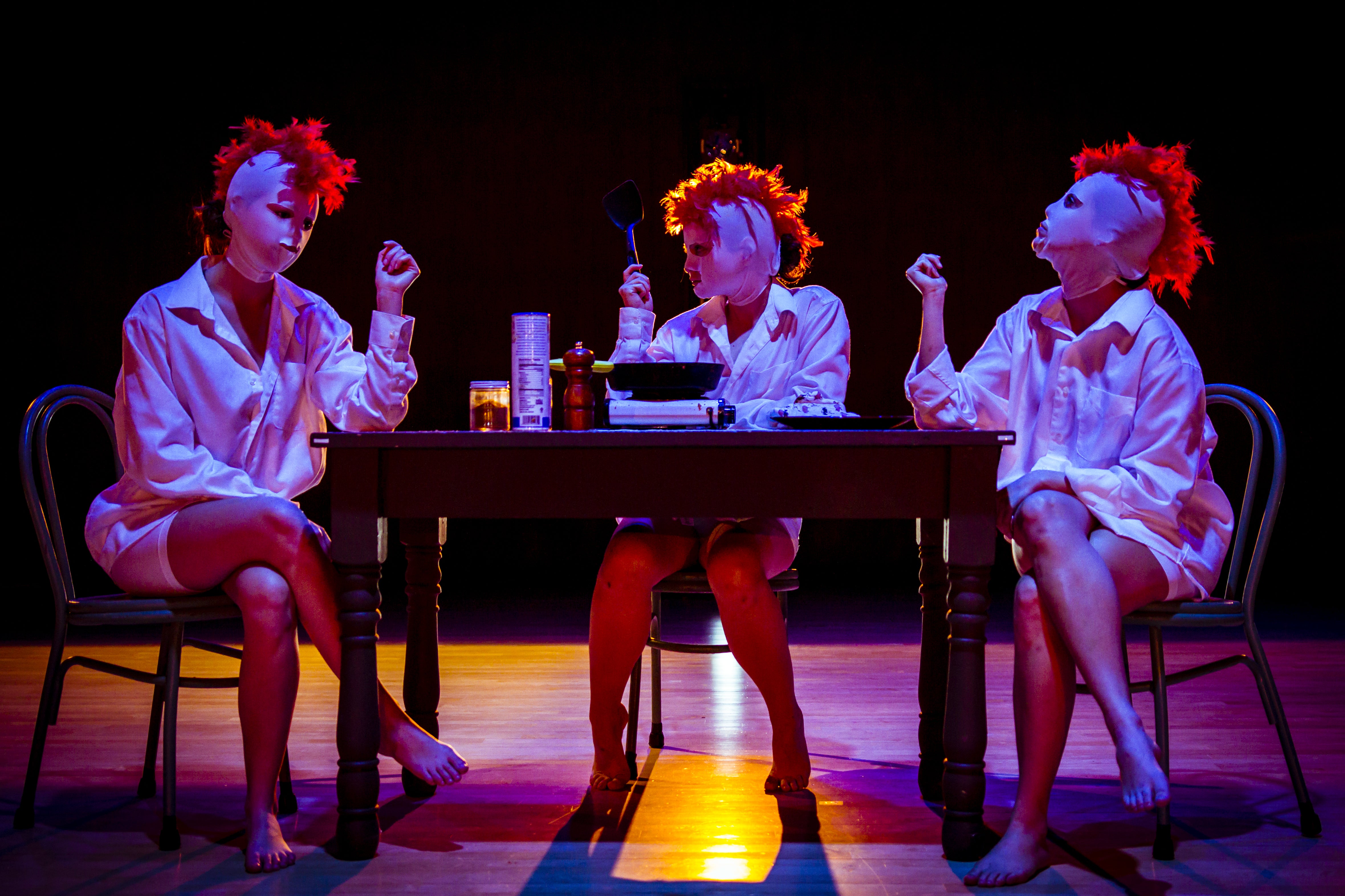 three students in feather headresses