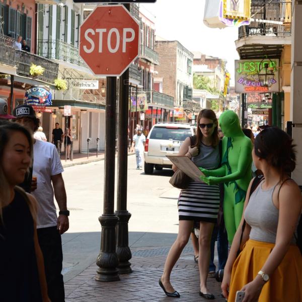 Person in a green suit looking at map with another person in San Francisco, California, United States