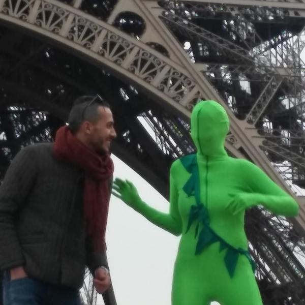 Person in green suit in at the Eiffel Tower Paris, France