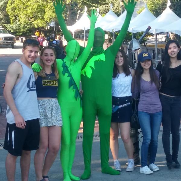 Two people in green suits in Berkeley, California, United States posing with others