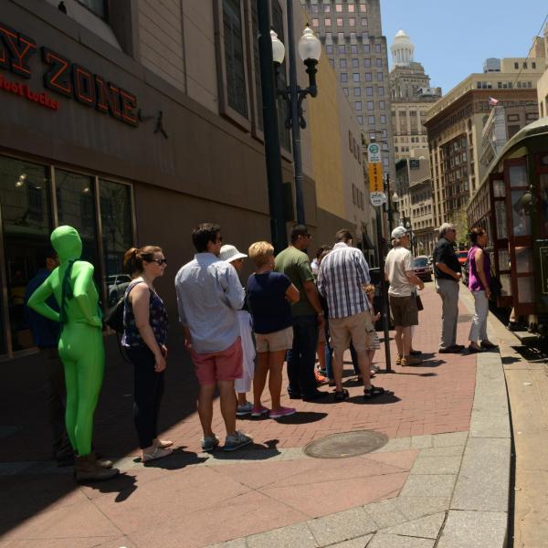 Person in a green suit waiting for a trolley in New Orleans, Louisiana, United States