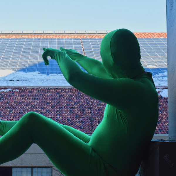 Person in a green suit at the campus indoor practice facility