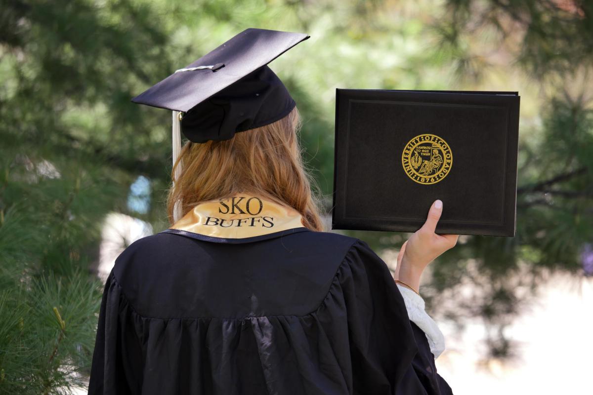 Graduating Student holding a diploma