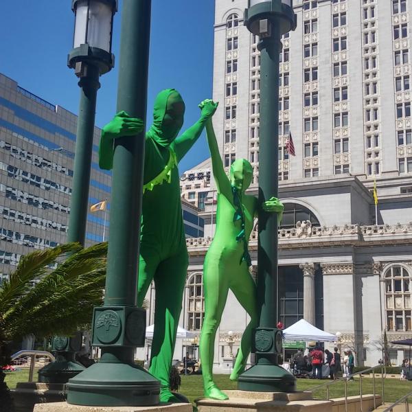 Two people in green suits in Oakland, California, United States