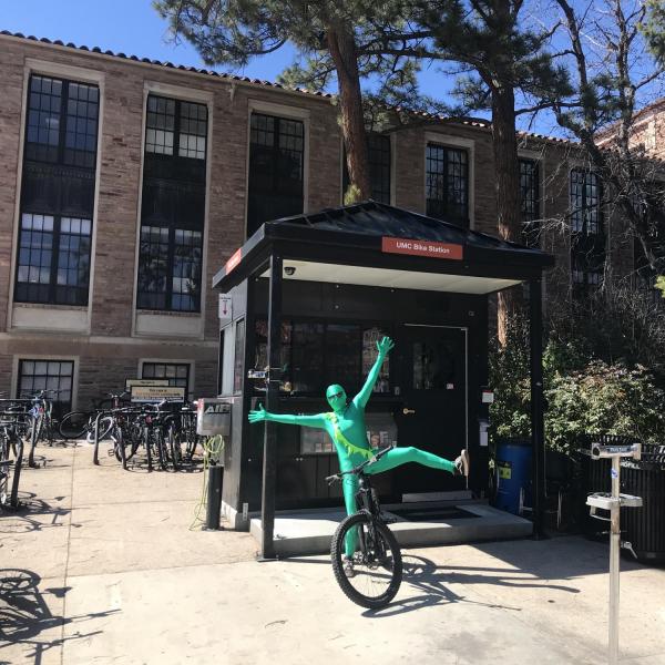 Person in a green suit at the campus bicycle center