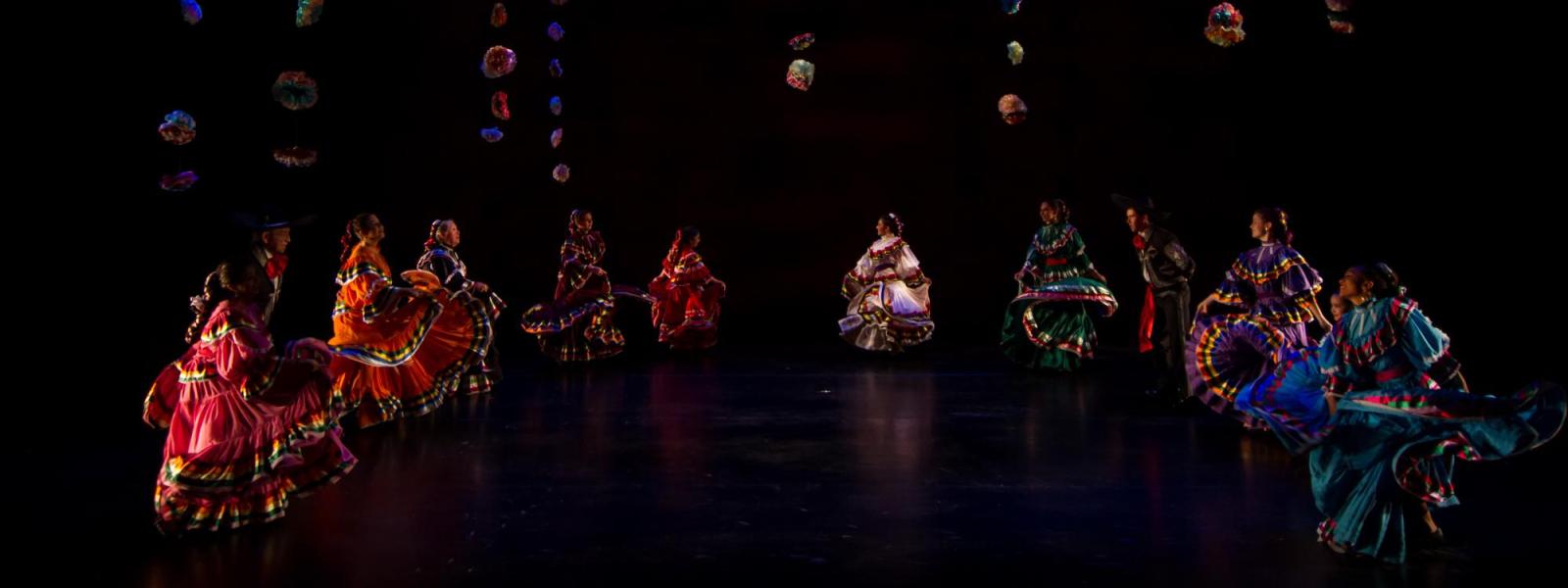 A group of dancers perform on stage