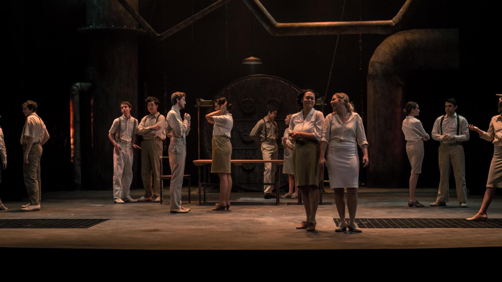 several student actors in small groups speak to each other